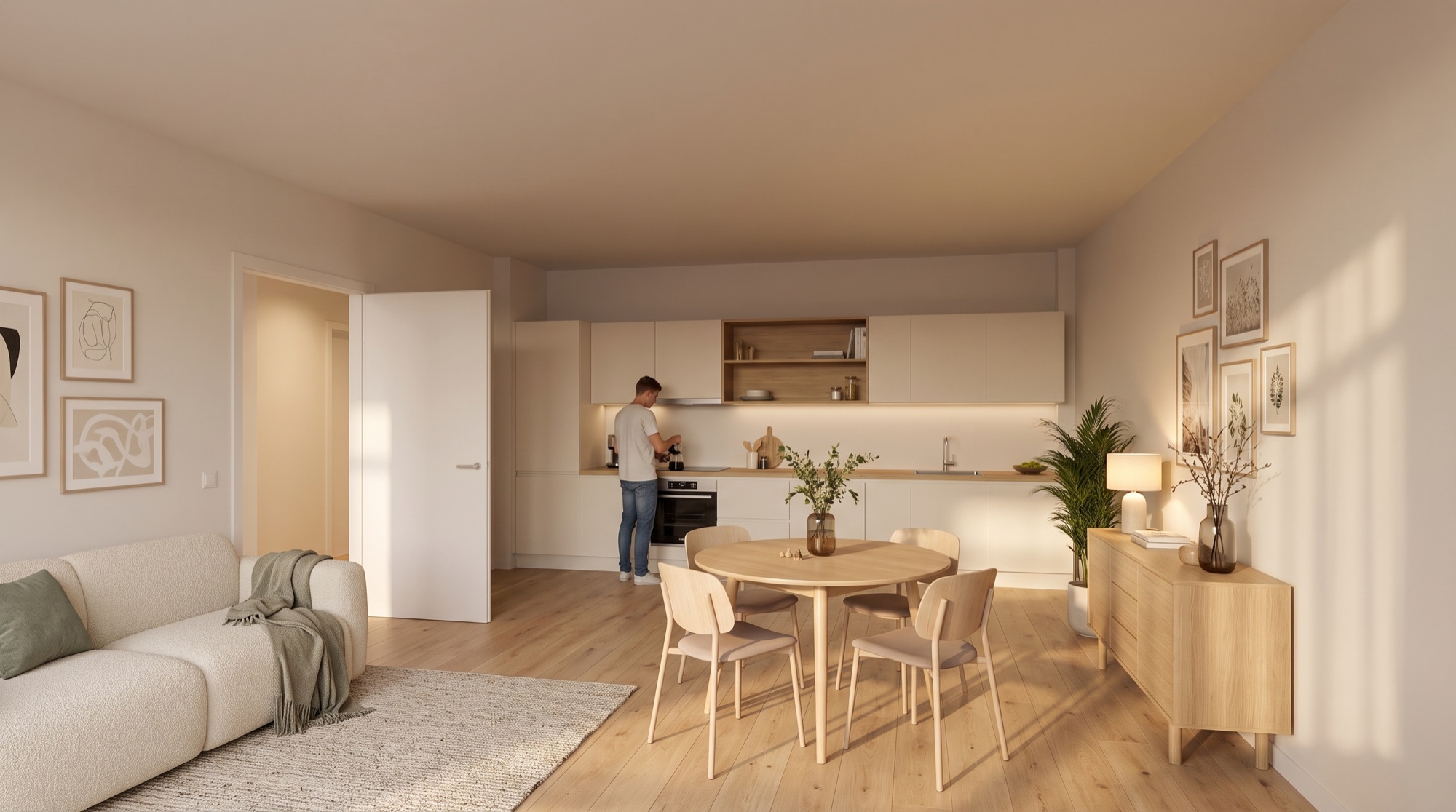 De woonkeuken van appartement C01 en C02: keukenwand, ronde eettafel en de zithoek in één ruimte